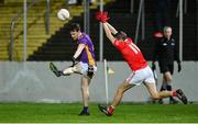 4 November 2023; Dara Mullin of Kilmacud Crokes kicks a point despite pressure from Sean Gannon of Éire Óg during the AIB Leinster GAA Football Senior Club Championship quarter-final match between Éire Óg and Kilmacud Crokes at Netwatch Cullen Park in Carlow. Photo by Seb Daly/Sportsfile