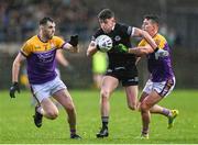 5 November 2023; Anthony Morgan of Kilcoo in action against Ryan Jones, left, and Shane McGullion of Derrygonnelly Harps during the AIB Ulster GAA Football Senior Club Championship round 1 match between Derrygonnelly Harps of Fermanagh and Kilcoo of Down at Brewster Park in Enniskillen, Fermanagh. Photo by Ramsey Cardy/Sportsfile