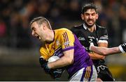 5 November 2023; Conall Jones of Derrygonnelly Harps is tackled by Niall Branagan of Kilcoo during the AIB Ulster GAA Football Senior Club Championship round 1 match between Derrygonnelly Harps of Fermanagh and Kilcoo of Down at Brewster Park in Enniskillen, Fermanagh. Photo by Ramsey Cardy/Sportsfile