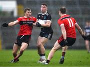5 November 2023; Ruadhan O'Connor of Newcastle West in action against Hugh Bourke, left, and Robbie Bourke of Adare during the Limerick County Senior Club Football Championship final match between Adare and Newcastle West at TUS Gaelic Grounds in Limerick. Photo by Tom Beary/Sportsfile