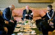 10 November 2023; President of Ireland Michael D Higgins, holding the official matchday programme, receives 2023 Men's FAI Cup finalist Keith Buckley of Bohemians and FAI President Gerry McAnaney at Áras an Uachtaráin in the Phoenix Park, Dublin, ahead of the 2023 Sports Direct Men's FAI Cup Final between Bohemians and St Patrick's Athletic to be held on Sunday at the Aviva Stadium in Dublin. Photo by Stephen McCarthy/Sportsfile