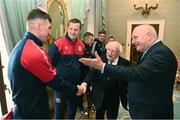 10 November 2023; President of Ireland Michael D Higgins receives 2023 Men's FAI Cup finalist Joe Redmond of St Patrick's Athletic and manager Jon Daly in the company of FAI President Gerry McAnaney, right, at Áras an Uachtaráin in the Phoenix Park, Dublin, ahead of the 2023 Sports Direct Men's FAI Cup Final between Bohemians and St Patrick's Athletic to be held on Sunday at the Aviva Stadium in Dublin. Photo by Stephen McCarthy/Sportsfile