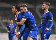 10 November 2023; Connor Parsons of Waterford, left, celebrates with team-mates Darragh Power, centre, and Barry Crowe Baggley after scoring their side's first goal during the SSE Airtricity Men's Promotion / Relegation play-off match between Waterford and Cork City at Tallaght Stadium in Dublin. Photo by Tyler Miller/Sportsfile