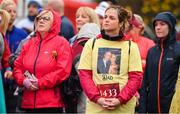 12 November 2023; Participants watch a big screen showing the names and photos of those who they have lost before the start of the Remembrance Run 5K, supported by Silver Stream Healthcare, at the Phoenix Park in Dublin. Photo by Brendan Moran/Sportsfile