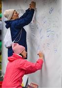 12 November 2023; Participants sign the wall of remembrance before the start of the Remembrance Run 5K, supported by Silver Stream Healthcare, at the Phoenix Park in Dublin. Photo by Brendan Moran/Sportsfile