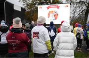 12 November 2023; Participants watch the big screen, showing the names and photos of those lost, before the Remembrance Run 5K, supported by Silver Stream Healthcare, at the Phoenix Park in Dublin. Photo by Brendan Moran/Sportsfile