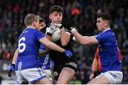 12 November 2023; Anthony Morgan of Kilcoo is tackled by Donal Morgan, left, and Michael McCarville of Scotstown during the AIB Ulster GAA Football Senior Club Championship quarter-final match between Kilcoo, Down, and Scotstown, Monaghan, at Pairc Esler in Newry, Down. Photo by Stephen Marken/Sportsfile