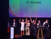 11 November 2023; Attendees, from left, MC Greg O'Shea, Sarah Lavin, Erin King, Marian Heffernan, Rob Heffernan, Jordan Conroy, and Noel Hendricks on stage at the Team Ireland Olympic Ball at the Mansion House in Dublin. The event was a joint celebration of the brilliant performances of Team Ireland athletes at the European Games this summer, as well as the announcement of the winners of the Olympic Federation of Ireland Annual Awards. The event was attended by the Minister for Tourism, Culture, Arts, Gaeltacht, Sport and Media, Catherine Martin TD, Minister of State for Sport and Physical Education, Thomas Byrne TD, Olympic medallists, European Games athletes, Team Ireland Sponsors and Partners, Sport Ireland and the wider Olympic family. Photo by David Fitzgerald/Sportsfile
