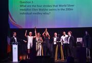 11 November 2023; Attendees, from left, MC Greg O'Shea, Sarah Lavin, Erin King, Marian Heffernan, Rob Heffernan, Jordan Conroy, and Noel Hendricks on stage at the Team Ireland Olympic Ball at the Mansion House in Dublin. The event was a joint celebration of the brilliant performances of Team Ireland athletes at the European Games this summer, as well as the announcement of the winners of the Olympic Federation of Ireland Annual Awards. The event was attended by the Minister for Tourism, Culture, Arts, Gaeltacht, Sport and Media, Catherine Martin TD, Minister of State for Sport and Physical Education, Thomas Byrne TD, Olympic medallists, European Games athletes, Team Ireland Sponsors and Partners, Sport Ireland and the wider Olympic family. Photo by David Fitzgerald/Sportsfile