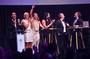 11 November 2023; Attendees, from left, MC Greg O'Shea, Sarah Lavin, Erin King, Marian Heffernan, Rob Heffernan, and Noel Hendricks on stage at the Team Ireland Olympic Ball at the Mansion House in Dublin. The event was a joint celebration of the brilliant performances of Team Ireland athletes at the European Games this summer, as well as the announcement of the winners of the Olympic Federation of Ireland Annual Awards. The event was attended by the Minister for Tourism, Culture, Arts, Gaeltacht, Sport and Media, Catherine Martin TD, Minister of State for Sport and Physical Education, Thomas Byrne TD, Olympic medallists, European Games athletes, Team Ireland Sponsors and Partners, Sport Ireland and the wider Olympic family. Photo by David Fitzgerald/Sportsfile