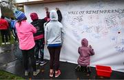 12 November 2023; Participants sign the wall of remembrance before the Remembrance Run 5K, supported by Silver Stream Healthcare, at the Phoenix Park in Dublin. Photo by Brendan Moran/Sportsfile