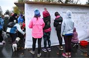12 November 2023; Participants sign the wall of remembrance before the Remembrance Run 5K, supported by Silver Stream Healthcare, at the Phoenix Park in Dublin. Photo by Brendan Moran/Sportsfile