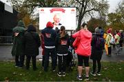 12 November 2023; Participants watch the big screen for names of loved ones before the Remembrance Run 5K, supported by Silver Stream Healthcare, at the Phoenix Park in Dublin. Photo by Brendan Moran/Sportsfile