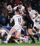 17 November 2023; Henco van Wyk of Emirates Lions is tackled by Jake Flannery, 10, and Jacob Stockdale of Ulster during the United Rugby Championship match between Ulster and Emirates Lions at Kingspan Stadium in Belfast. Photo by Ramsey Cardy/Sportsfile