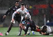 17 November 2023; Edwill van der Merwe of Emirates Lions is tackled by Jake Flannery, left, and Reuben Crothers of Ulster during the United Rugby Championship match between Ulster and Emirates Lions at Kingspan Stadium in Belfast. Photo by Ramsey Cardy/Sportsfile