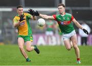 18 November 2023; Brian Cogger of Corofin in action against Sean Regan of Ballina Stephenites during the AIB Connacht GAA Football Senior Club Championship Semi-Final match between Corofin, Galway, and Ballina Stephenites, Mayo, at Pearse Stadium, Galway. Photo by Ray Ryan/Sportsfile