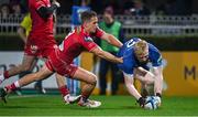 18 November 2023; Jamie Osborne of Leinster scores his side's fifth try despite the efforts of Kieran Hardy of Scarlets  during the United Rugby Championship match between Leinster and Scarlets at the RDS Arena in Dublin. Photo by Sam Barnes/Sportsfile