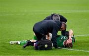 18 November 2023; Nathan Collins of Republic of Ireland is treated for an injurt by Republic of Ireland team doctor Sean Carmody and Republic of Ireland athletic therapist Colum O’Neill after the UEFA EURO 2024 Championship qualifying group B match between Netherlands and Republic of Ireland at Johan Cruijff ArenA in Amsterdam, Netherlands. Photo by Stephen McCarthy/Sportsfile