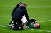18 November 2023; Nathan Collins of Republic of Ireland is treated for an injury by Republic of Ireland team doctor Sean Carmody and Republic of Ireland athletic therapist Colum O’Neill after the UEFA EURO 2024 Championship qualifying group B match between Netherlands and Republic of Ireland at Johan Cruijff ArenA in Amsterdam, Netherlands. Photo by Stephen McCarthy/Sportsfile
