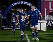 18 November 2023; Matchday mascots Elliott O'Beirne, aged eight, runs out with James Ryan of Leinster and Ryan O'Hara, aged seven, with Garry Ringrose before the United Rugby Championship match between Leinster and Scarlets at the RDS Arena in Dublin. Photo by Harry Murphy/Sportsfile