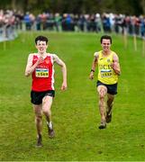 19 November 2023; Niall Murphy of Ennis Track AC, Clare, left, and Jonas Stafford of UCD AC, Dublin, race for the finish line in the Mens U18 & Junior 5000m during the 123.ie National Senior & Even Age Cross Country Championships at Gowran Demesne in Kilkenny. Photo by Ben McShane/Sportsfile