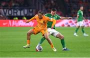 18 November 2023; Xavi Simons of Netherlands in action against Josh Cullen of Republic of Ireland during the UEFA EURO 2024 Championship qualifying group B match between Netherlands and Republic of Ireland at Johan Cruijff ArenA in Amsterdam, Netherlands. Photo by Seb Daly/Sportsfile