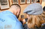 20 November 2023; Andrew Porter is shown a photograph of his father, Ernie Porter, a former pupil of the school, by Principal Emma Raughter after a squad training session on the Leinster Rugby 12 Counties Tour at Kilkenny College in Kilkenny. Photo by Harry Murphy/Sportsfile