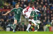 20 November 2023; Mohamed Daramy of Denmark in action against George Saville of Northern Ireland during the UEFA EURO 2024 Qualifying Round Group H match between Northern Ireland and Denmark at the National Stadium at Windsor Park in Belfast. Photo by Ramsey Cardy/Sportsfile