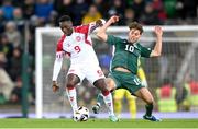 20 November 2023; Mohamed Daramy of Denmark in action against Dion Charles of Northern Ireland during the UEFA EURO 2024 Qualifying Round Group H match between Northern Ireland and Denmark at the National Stadium at Windsor Park in Belfast. Photo by Ramsey Cardy/Sportsfile
