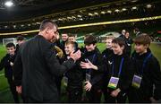 21 November 2023; Republic of Ireland manager Stephen Kenny meets ballkids from St. Kevin's Boys before the international friendly match between Republic of Ireland and New Zealand at Aviva Stadium in Dublin. Photo by Stephen McCarthy/Sportsfile