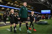 21 November 2023; James McClean of Republic of Ireland walks out with his children, from left, Allie Mae, Willow Ivy and Junior James before the international friendly match between Republic of Ireland and New Zealand at Aviva Stadium in Dublin. Photo by Stephen McCarthy/Sportsfile