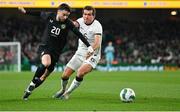 21 November 2023; Mikey Johnston of Republic of Ireland in action against Joe Bell of New Zealand during the international friendly match between Republic of Ireland and New Zealand at Aviva Stadium in Dublin. Photo by Seb Daly/Sportsfile