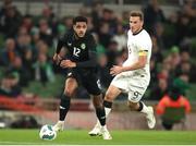 21 November 2023; Andrew Omobamidele of Republic of Ireland in action against Chris Wood of New Zealand during the international friendly match between Republic of Ireland and New Zealand at the Aviva Stadium in Dublin. Photo by Michael P Ryan/Sportsfile