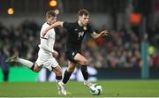 21 November 2023; Jayson Molumby of Republic of Ireland in action against Callum McCowatt of New Zealand during the international friendly match between Republic of Ireland and New Zealand at Aviva Stadium in Dublin. Photo by Stephen McCarthy/Sportsfile
