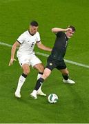 21 November 2023; Evan Ferguson of Republic of Ireland in action against Michael Boxall of New Zealand during the international friendly match between Republic of Ireland and New Zealand at Aviva Stadium in Dublin. Photo by Ben McShane/Sportsfile