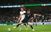 21 November 2023; Evan Ferguson of Republic of Ireland in action against Marko Stamenic of New Zealand during the international friendly match between Republic of Ireland and New Zealand at Aviva Stadium in Dublin. Photo by Stephen McCarthy/Sportsfile