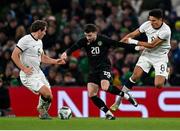21 November 2023; Mikey Johnston of Republic of Ireland in action against Marko Stamenic, right, and Joe Bell of New Zealand during the international friendly match between Republic of Ireland and New Zealand at Aviva Stadium in Dublin. Photo by Stephen McCarthy/Sportsfile