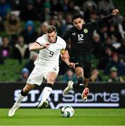 21 November 2023; Andrew Omobamidele of Republic of Ireland in action against Chris Wood of New Zealand during the international friendly match between Republic of Ireland and New Zealand at Aviva Stadium in Dublin. Photo by Piaras Ó Mídheach/Sportsfile