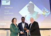 22 November 2023; Israel Olatunde of UCD AC, Dublin, is presented with the Athletics Ireland Inspirational Performance on Irish Soil Award by RSA Insurance Managing Director Elaine Robinson and Athletics Ireland President John Cronin during the 123.ie National Athletics Awards at Crowne Plaza Hotel in Santry, Dublin. He received the award is in recognition of his record breaking 6.57 clocked in the final of the 60m at the 123.ie National Indoor Championships on February 19th 2023. A full list of winners from the event can be found at AthleticsIreland.ie Photo by Sam Barnes/Sportsfile