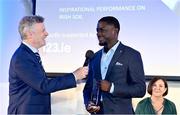 22 November 2023; Israel Olatunde of UCD AC, Dublin, is interviewed by MC Greg Allen after winning the Athletics Ireland Inspirational Performance on Irish Soil Award during the 123.ie National Athletics Awards at Crowne Plaza Hotel in Santry, Dublin. He received the award is in recognition of his record breaking 6.57 clocked in the final of the 60m at the 123.ie National Indoor Championships on February 19th 2023. A full list of winners from the event can be found at AthleticsIreland.ie Photo by Sam Barnes/Sportsfile