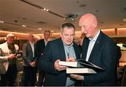 24 November 2023; Former Kilkenny hurling manager Brian Cody, right, signs autographs during the launch of Allianz Cumann na mBunscol 50th anniversary book, &quot;50 Bliain ag Fás’, at Croke Park in Dublin. Photo by Sam Barnes/Sportsfile