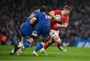 25 November 2023; Jack Crowley of Munster is tackled by Caelan Doris, centre, and Robbie Henshaw of Leinster during the United Rugby Championship match between Leinster and Munster at the Aviva Stadium in Dublin. Photo by David Fitzgerald/Sportsfile