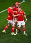 25 November 2023; Craig Casey of Munster, right, celebrates with team-mates John Hodnett, centre, and Jack Crowley after scoring his side's first try during the United Rugby Championship match between Leinster and Munster at the Aviva Stadium in Dublin. Photo by Tyler Miller/Sportsfile