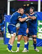 25 November 2023; Jamison Gibson-Park of Leinster, centre, is congratulated by team-mates Josh van der Flier, left, and Caelan Doris after scoring his side's first try during the United Rugby Championship match between Leinster and Munster at the Aviva Stadium in Dublin. Photo by Sam Barnes/Sportsfile