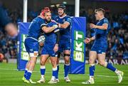 25 November 2023; Jamison Gibson-Park of Leinster, second from left, is congratulated by team-mates, from left, Josh van der Flier, Caelan Doris and Garry Ringrose after scoring his side's first try during the United Rugby Championship match between Leinster and Munster at the Aviva Stadium in Dublin. Photo by Sam Barnes/Sportsfile