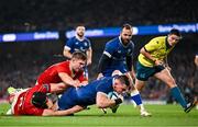 25 November 2023; Dan Sheehan of Leinster dives over to score his side's second try despite the efforts of Gavin Coombes and Jack Crowley of Munster during the United Rugby Championship match between Leinster and Munster at the Aviva Stadium in Dublin. Photo by Harry Murphy/Sportsfile