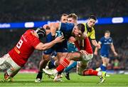 25 November 2023; Dan Sheehan of Leinster evades the tackle of Gavin Coombes and Jack Crowley of Munster on his way to scoring his side's second try during the United Rugby Championship match between Leinster and Munster at the Aviva Stadium in Dublin. Photo by Harry Murphy/Sportsfile