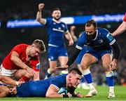 25 November 2023; Dan Sheehan of Leinster dives over to score his side's second try despite the tackle of Gavin Coombes and Jack Crowley of Munster during the United Rugby Championship match between Leinster and Munster at the Aviva Stadium in Dublin. Photo by Harry Murphy/Sportsfile