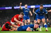 25 November 2023; Dan Sheehan of Leinster dives over to score his side's second try despite the tackle of Gavin Coombes and Jack Crowley of Munster during the United Rugby Championship match between Leinster and Munster at the Aviva Stadium in Dublin. Photo by Harry Murphy/Sportsfile