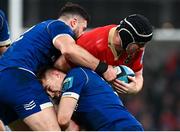 25 November 2023; Rory Scannell of Munster is tackled by Robbie Henshaw and Garry Ringrose of Leinster during the United Rugby Championship match between Leinster and Munster at the Aviva Stadium in Dublin. Photo by Harry Murphy/Sportsfile